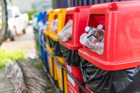 Close up image different colored recycle garbage trash Bins in the park. Stock Photos
