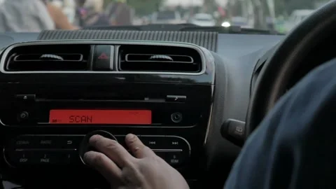 Close up image of driver's hand press button on car radio, listening music  Stock Footage 140413297