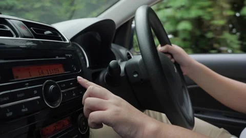 Close up image of driver's hand press button on car audio system, listening m Stock Footage 150786909