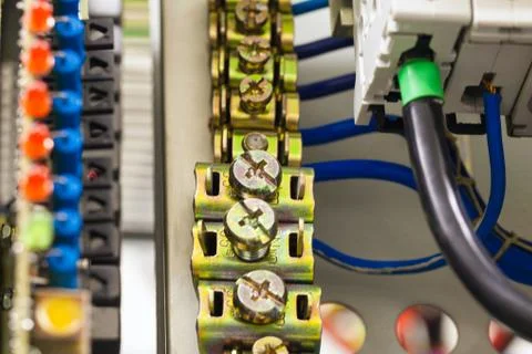 Close-up image of electrical wires is connected to cuprum clamps in power system Stock Photos