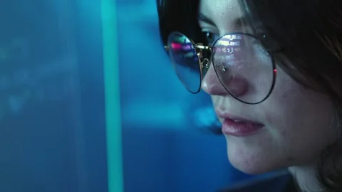 Close-up image of female face, programmer, software developer looking on digital Stock Footage 245345761