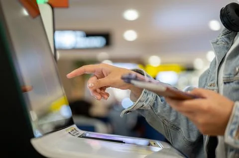 A close-up image, A female passenger is checking in for her flight at an ai.. Stock Photos