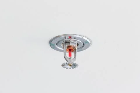 Close up image of fire sprinkler on white background. Fire sprinklers are p.. Stock Photos