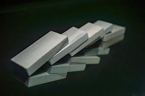 A close up image of five white rectangular blocks arranged in a domino effe.. 스톡 사진