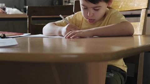 Close up image of focused schoolboy hands holding pencil writing and doing home Stock Footage 190511142