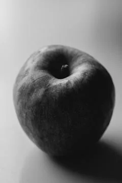 A close-up image of a fresh red and green apple with a smooth surface on a white Stock Photos