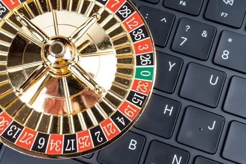 Close-up image of gold roulette wheel with ball spinning, potentially in digi Stock Photos