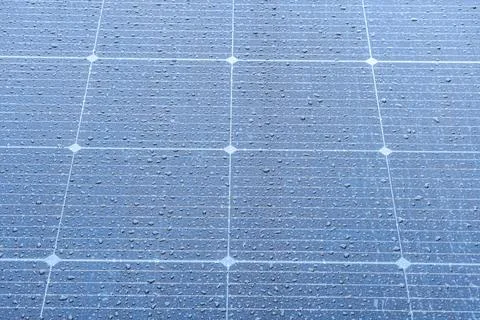 Close-up image of a grid-like solar panel with dark blue, black, and gray cel 写真素材