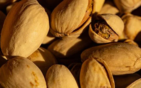 Close up image of a group of roasted and salty pistachio nuts. Stock Photos
