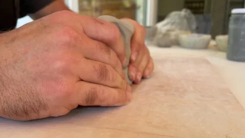 Close-up image of a hand shaping clay in a pottery class Video stock 278427549
