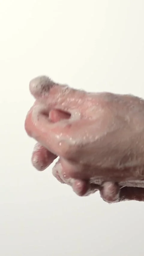 Close-up image of hands lathered in soap and bubbles, capturing the practice of Stock Footage 330377705
