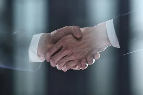 Close-up image of handshake between two colleagues. Stock Photos