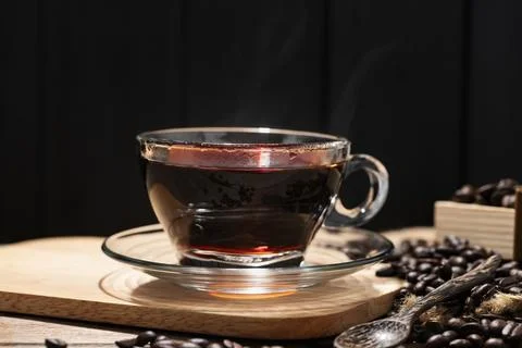 A close-up image of a hot coffee cup on a table, bathed in morning light, c.. Stock Photos