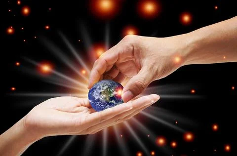 A close up image of a human hand holding a light-emitting planet Ecology conc Foto stock