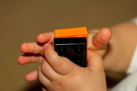 Close up image of an infant baby's hands as he or she is trying to interlock Stock Photos