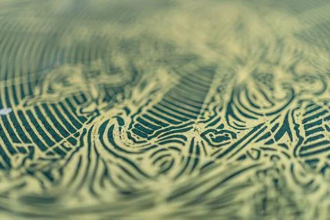 Close-up image of intricate gold patterns on high-quality woven fabric, sug.. Stock Photos
