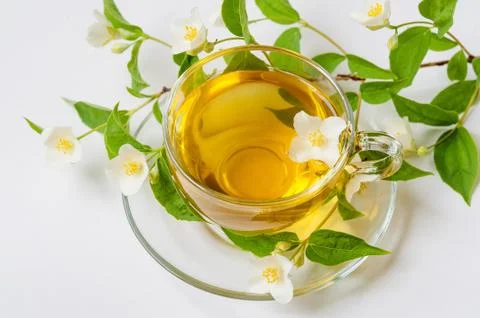 Close up image of jasmine tea in a glass cup over white background Stock Photos