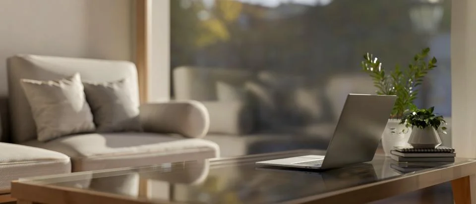 A close-up image of a laptop computer on a coffee table by the window in a .. Stock Illustration