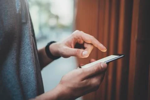 Close-up image of male hands using modern smartphone outdoor Stock Photos