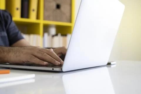Close up image of male hands using laptop. Typing, surfing internet. Stock Photos