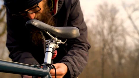 Close-up image of man adjusting bicycle at a public park, Zagreb. Stock Footage 127219087