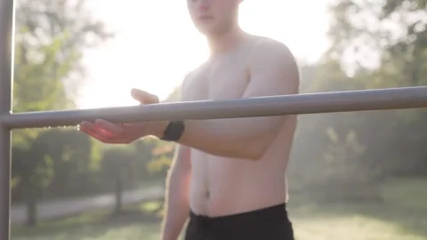 A Close Up Image of a Man with a Bare Torso Gripping a Barbell with water drops Видео 331252394