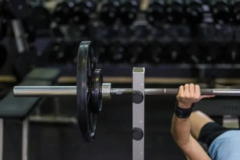 Close up image of man doing bench press at the gym. Stock Photos