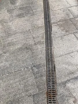 Close-up image of a metal rail on beigelight grey tiled surface, possibly i.. 写真素材
