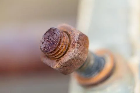 Close-up image of old rusty screw and bolt on steel surface with blurred Stock Photos