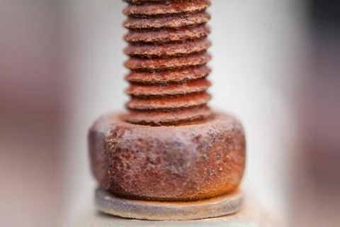 Close-up image of old rusty screw and bolt on steel surface with blurred Stock Photos