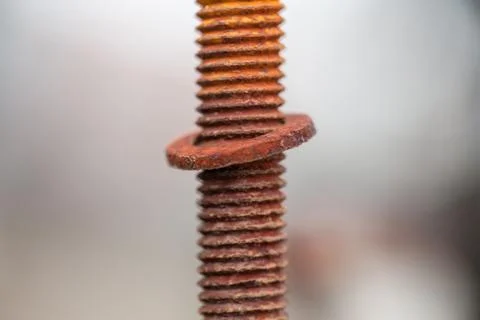 Close-up image of old rusty screw and bolt on steel surface with blurred Stock Photos