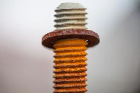 Close-up image of old rusty screw and bolt on steel surface with blurred Stock Photos