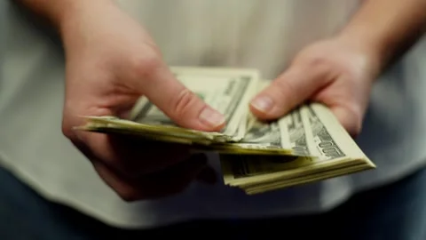 Close-up image of one hundred dollar bills dollars in hands. Video stock 265848894
