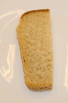 Close-up image of one slice of white bread against the white background . Stock Photos