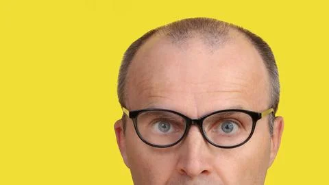Close-up image of part of a man's face with glasses. Stock Photos