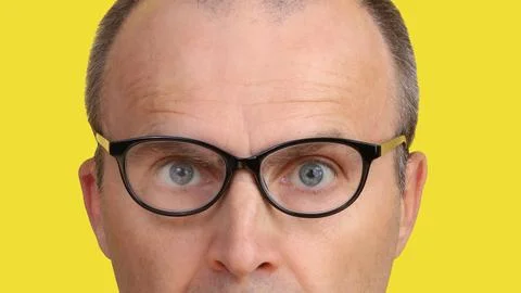 Close-up image of part of a man's face with glasses. Stock Photos