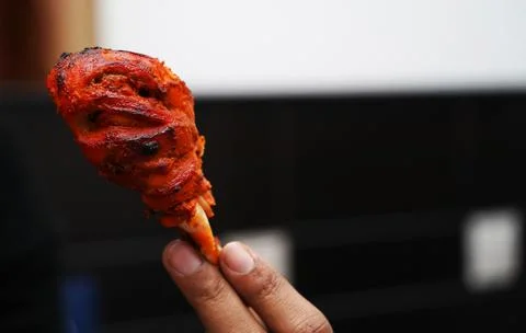 Close up image of a piece of fried and roasted chicken tandoori leg piece.Its a Stock Photos