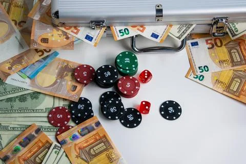 A close-up image of poker chips and dice with Euro and US Dollar bills scat.. Stock Photos