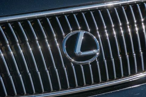 Close-up image of a polished Lexus front grille with reflective metallic logo Stock Photos