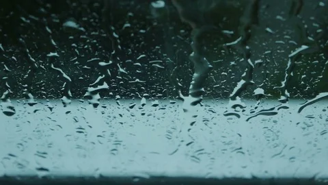 Close up image of rain drops falling on a window Stock Footage 77584598