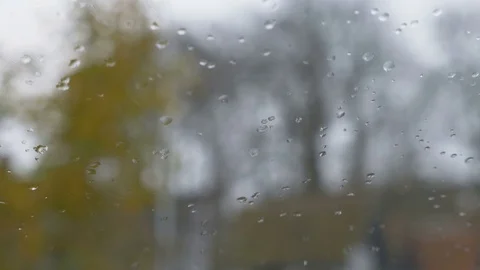 Close up image of rain drops falling on a window Stock Footage 82383004