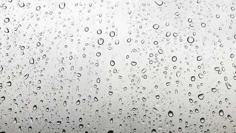 Close up image of raindrops falling on a window. Stock Footage 94202331