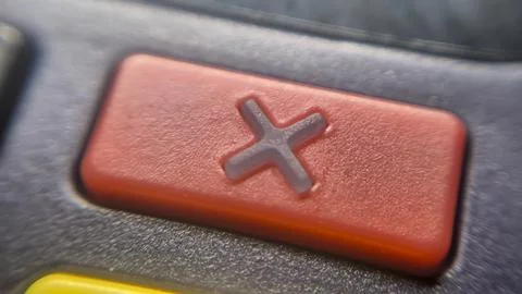 Close-up image of a red button featuring a cross symbol, commonly used to Stock Photos