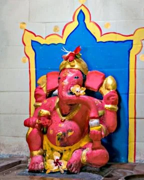 Close up image of red colored Lord ganesha idol at a temple in Velneshwar. Stock Photos