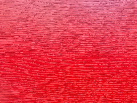 Close-up image of a red textured surface, possibly leather or vinyl Stock Photos