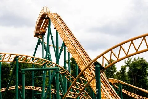 Close-up image of a rollercoaster track and the cloudy sky. Stock Photos