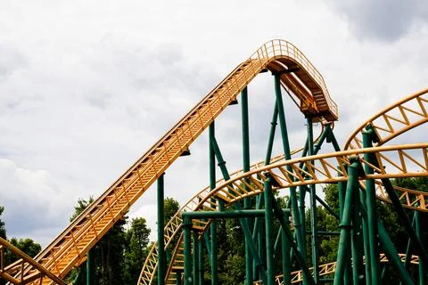 Close-up image of a rollercoaster track and the cloudy sky. Stock Photos