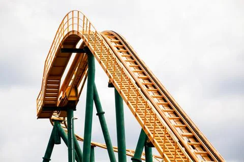 Close-up image of a rollercoaster track and the cloudy sky. Stock Photos