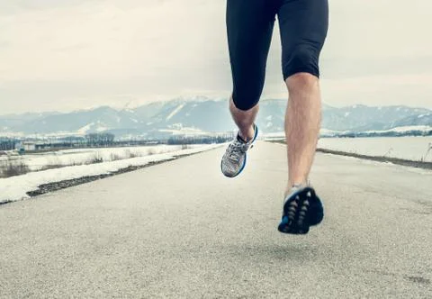 Close up image runner legs on asphalt Stock Photos