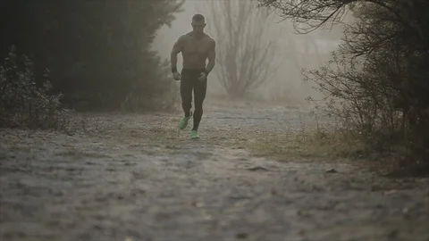 Close up image runner legs of nandsome caucasian athlete in running shoes and Видео 125865960